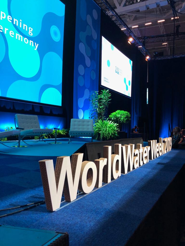 World Water Week sign on a stage.